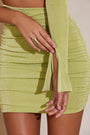 Close up view of Ali one shoulder flare sleeve mini dress in green